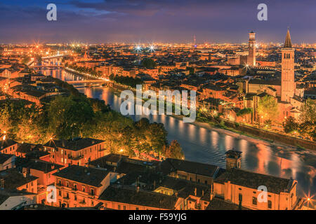 Santa Anastasia church and Torre dei Lamberti at dusk along the Adige river in Verona, Italy. Taken from piazzale castel san pie Stock Photo