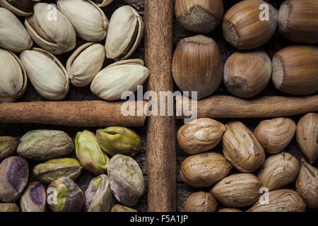 Composition with nuts, hazelnuts and pistachios close up on a cork bark Stock Photo