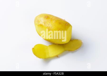 Single fresh potato, partially peeled Stock Photo