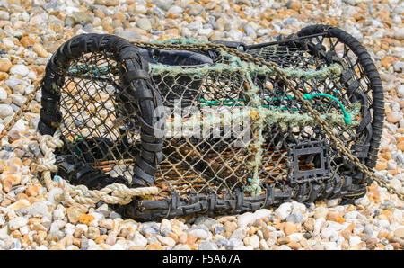 Lobster pot / Fish basket on a shingle beach. Stock Photo