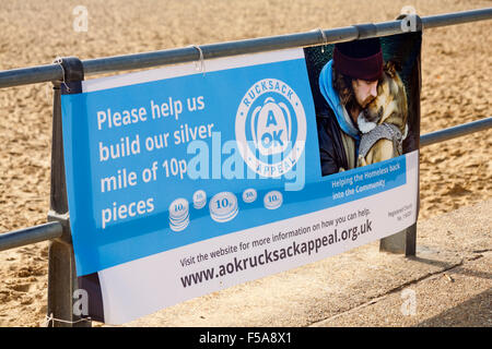 Bournemouth, Dorset, UK. 31 October 2015. An attempt is underway to build a mile of 10-pence pieces between Bournemouth and Boscombe Piers. The event, entitled Halloween Silver Mile, is in aid of the AOK Rucksack Appeal, which provides emergency rucksacks of essential items to new homeless people identified by professional agencies. Someone calculated that one mile is apparently 1609344 millimeters, a ten pence piece is 24 millimeters across, so assuming an exact perfectly straight mile and no gaps 67056 coins are needed, worth £6705.60 Credit:  Carolyn Jenkins/Alamy Live News Stock Photo