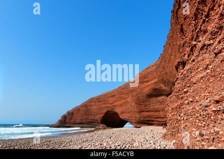 Natural sea-worn rock archways against clear blue sky at Legzira beach, Morocco. Stock Photo