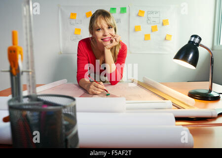 University student of Interior Design doing homeworks, reviewing housing project and completing project. The girl contemplates h Stock Photo