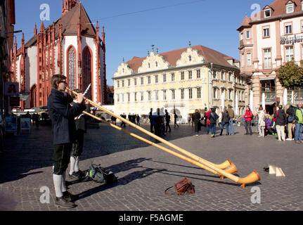 Musicians playing alphorns in Heidelberg's Old Town marketplace.  Heidelberg, Germany. Stock Photo