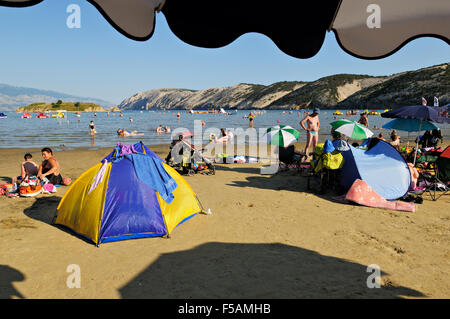 Under an umbrella at Paradise beach in Lopar, Rab island, Primorje-Gorski Kotar, Croatia Stock Photo