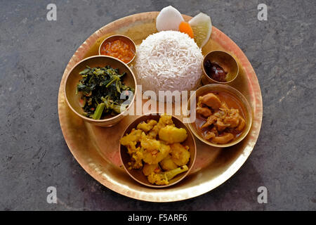 A round platter of Dal-bhat-tarkari made up of a selection of various dishes which include rice, vegetable curries, chutney and pickle. Nepal Stock Photo