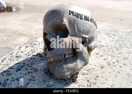 Concrete skull with words 'made in China' embossed. Stock Photo