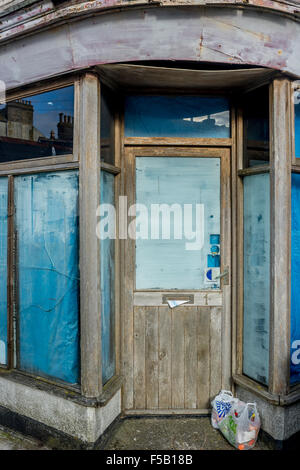 Doorway of an old, dilapidated, closed corner shop.  Shop closures, high street casualties, access denied, denial of access, barrier concepts. Stock Photo