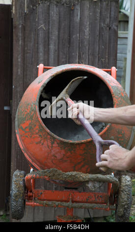 Shovelling in to a cement mixer Stock Photo