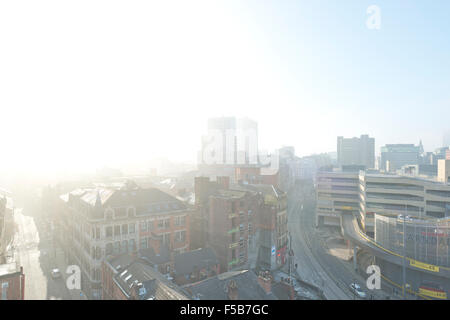 MANCHESTER, UK. 1st November 2015. A view of Shudehill, High Street and Withy Grove in the Northern Quarter area of Manchester as the sun breaks through dense fog in the city centre in the morning Credit:  Russell Hart/Alamy Live News. Stock Photo