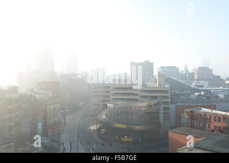 MANCHESTER, UK. 1st November 2015. A view of Shudehill, High Street and Withy Grove in the Northern Quarter area of Manchester as the sun breaks through dense fog in the city centre in the morning Credit:  Russell Hart/Alamy Live News. Stock Photo