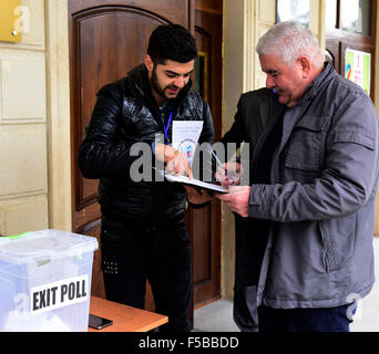 (151101) -- BAKU, Nov. 1, 2015 (Xinhua) -- An electoral worker checks a voter's identity at a polling station in Baku, Azerbaijan held its 5th parliamentary elections early Sunday to pick the 125 deputies for Azerbaijan's National Assembly, or the parliament. (Xinhua/Tofiq Babayev) Stock Photo