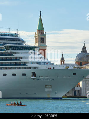 Cruise ship passing in front of San Giorgio Maggiore island with a canoe in the foreground Venice Veneto Italy Europe Stock Photo