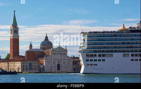 Cruise liner attached to tugboat passing Basilica Di San Giorgio Maggiore Venice Veneto Italy Europe Stock Photo