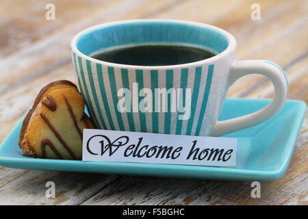 Welcome home card with cup of black coffee and heart shaped biscuit Stock Photo