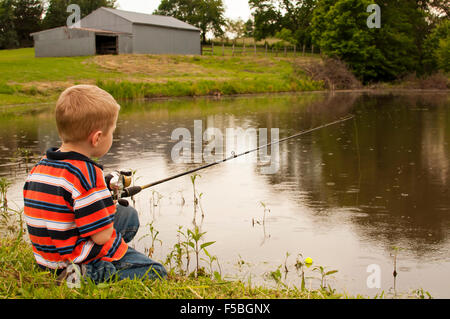 Young boy fishing in pond. Stock Photo