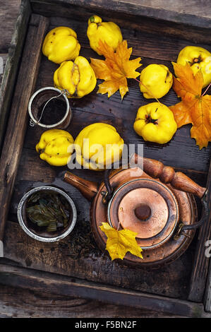 Copper kettle brewing and quinces in an old stylish derevna box Stock Photo