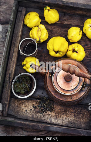 Copper kettle brewing and quinces in an old stylish derevna box Stock Photo