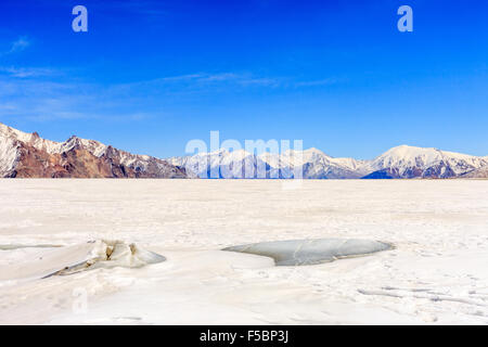 Icy shoreline of the frozen Pangong lake in Ladakh Stock Photo