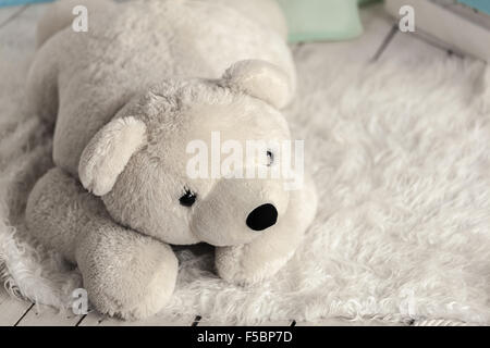 white soft toy bear in a children's room Stock Photo