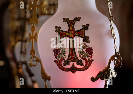 Lamps over the Stone of the Anointing or Stone of Unction inside the church of Holy Sepulchre in the Christian Quarter old city East Jerusalem Israel Stock Photo