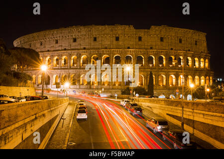 Colosseum at night with colorful blurred traffic lights. Rome - Italy. Stock Photo