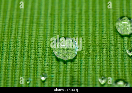 drops on a green waterproof cloth Stock Photo