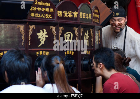 Shanghai Puppet Show in the ancient town, Shanhai. The Chinese love their children, and are restricted, if city dwellers, to but Stock Photo