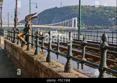 The Little Princess bronze sculpture sitting on the railings by the river Danube, Budapest, Hungary. Stock Photo