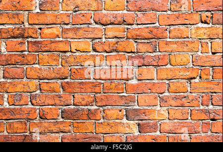Weathered stained old brick wall as background Stock Photo
