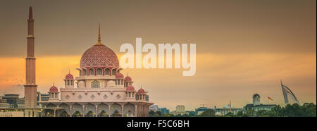 Sunset over Putrajaya Mosque and Panorama of Kuala Lumpur, Malaysia. Stock Photo