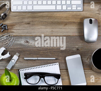 Simple workplace setup on rustic wooden desktop. Top view. Stock Photo