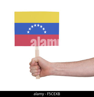 Hand holding small card, isolated on white - Flag of Venezuela Stock Photo