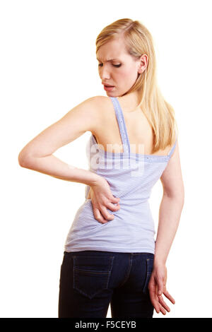 Young blonde woman touching her aching back Stock Photo