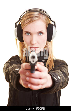 Young female shooter with pistol and ear protection Stock Photo