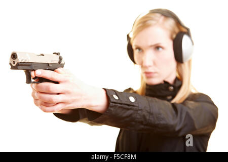 Young female shooter with pistol and ear protection Stock Photo