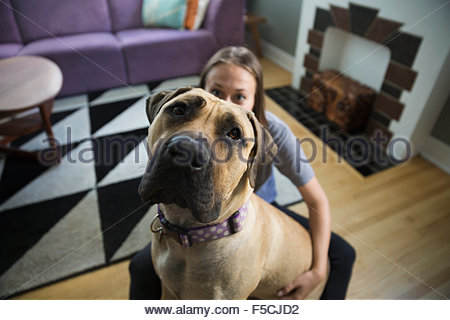 Portrait dog and woman in living room
