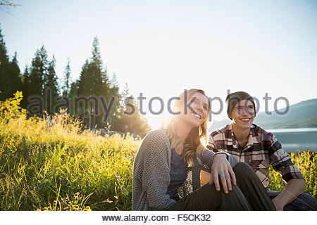 Young couple relaxing in sunny grass