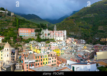Vernazza, one of the 5 Cinque Terre Villages with hills and vineyards in the background, Italy Stock Photo