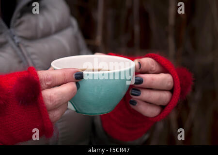 Female hands holding cup of hot coffee Stock Photo