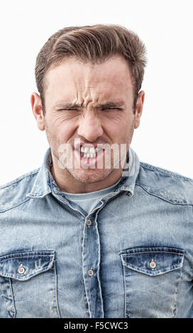 Portrait of a young angry man isolated against a white background. Stock Photo
