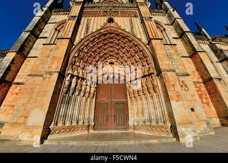 Portugal: Main facade and gothic portal of the Monastery Santa Maria da Vitoria in Batalha Stock Photo