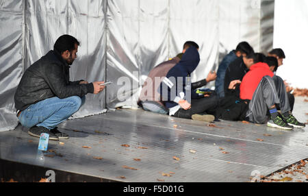 Berlin, Germany. 02nd Nov, 2015. Refugees wait in a tent at the State Office for Health and Social Affairs (LaGeSo) in Berlin, Germany, 02 November 2015. Photo: BRITTA PEDERSEN/dpa/Alamy Live News Stock Photo