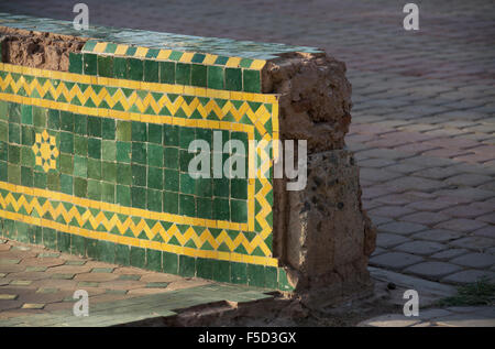 A damaged tiled wall decorated in traditional Moroccan style mosaic design.  Main Souk, Marrakech, Marrakesh, Morocco. Stock Photo