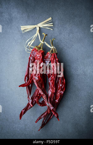 Dried hot red chili peppers on dark background Stock Photo
