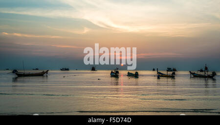 Long-tail boats in sea at sunset, Koh Tao Island, Gulf of Thailand, Thailand Stock Photo