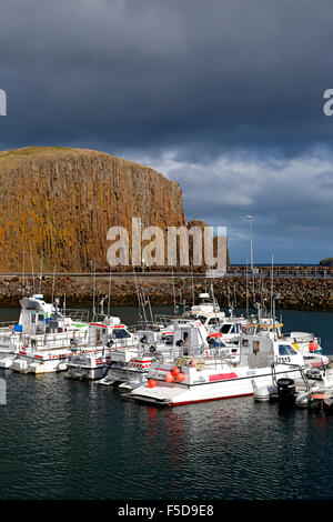 Boats, Stykkisholmur Harbor, and basalt island Sugandisey in background, Stykkisholmur, Iceland Stock Photo
