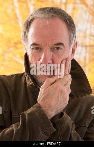 Elderly man suffering from toothache Stock Photo