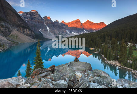 A man enjoying the view of Moraine Lake by sunrise, Banff National Park, Alberta, Canada, America (Canadian Rocky Mountains). Stock Photo