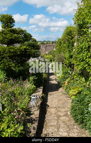 Stone path leading down a  beautiful garden participating in the Open Gardens Weekend in the Burford Festival, Oxfordshire, UK Stock Photo